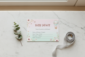 4x6 baby shower invitation postcard on white marble surface in natural daylight